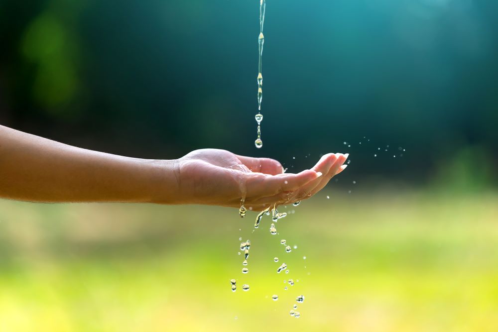 Water Dripping Onto a Woman's Outstretched Hand